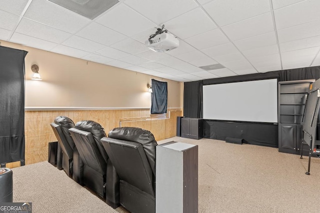 cinema with a wainscoted wall, visible vents, carpet floors, and a paneled ceiling