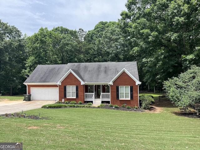 4100 Jewel Rdg, Monroe, GA 30655 - ranch-style house with covered porch, brick siding, a garage, a front yard, and driveway