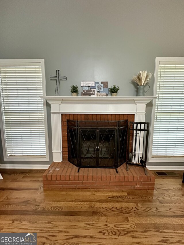 4100 Jewel Rdg, Monroe, GA 30655 - detailed view of a brick fireplace, wood finished floors, and baseboards