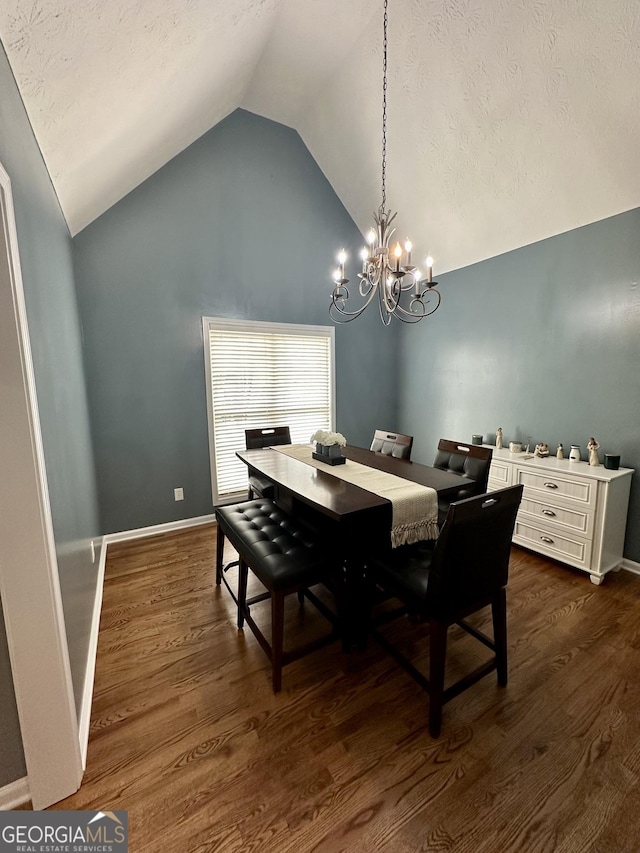 4100 Jewel Rdg, Monroe, GA 30655 - dining room with a chandelier, dark wood-type flooring, high vaulted ceiling, baseboards, and a textured ceiling