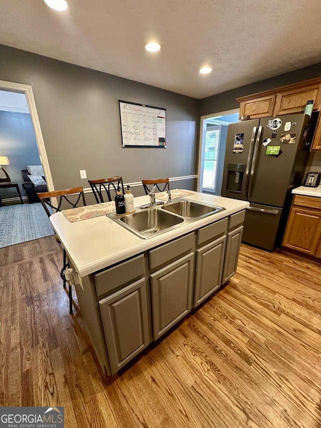 4100 Jewel Rdg, Monroe, GA 30655 - kitchen with stainless steel fridge with ice dispenser, a sink, a center island with sink, light wood-style floors, and recessed lighting