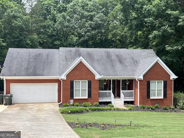 4100 Jewel Rdg, Monroe, GA 30655 - ranch-style house featuring covered porch, concrete driveway, brick siding, a front yard, and an attached garage