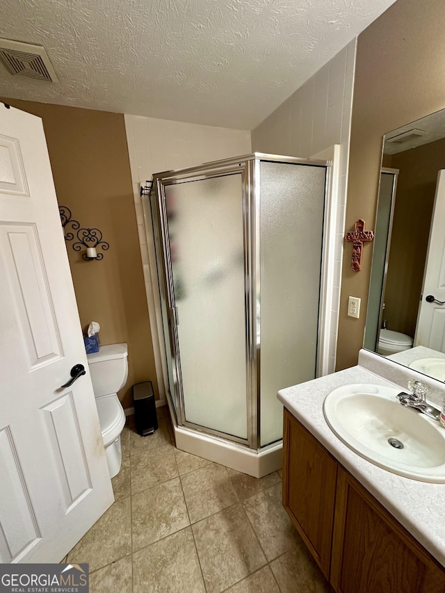 4100 Jewel Rdg, Monroe, GA 30655 - bathroom with toilet, a shower stall, tile patterned floors, vanity, and a textured ceiling
