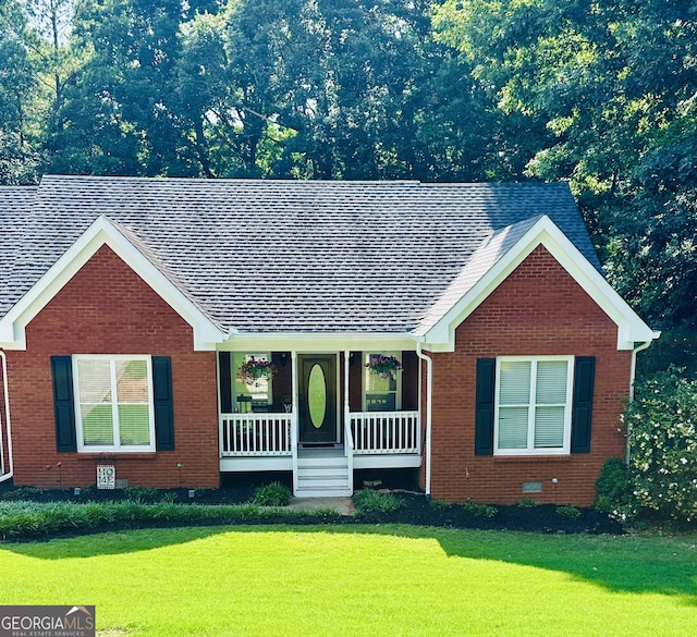 4100 Jewel Rdg, Monroe, GA 30655 - ranch-style house with a porch, brick siding, a front yard, and a shingled roof