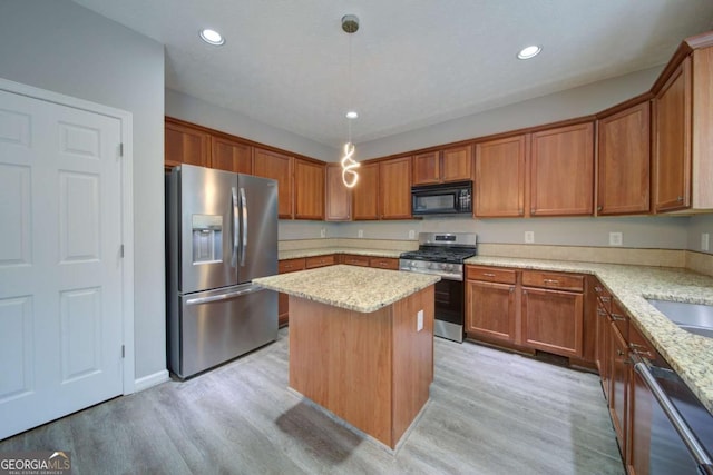 830 Buffington Way, Canton, GA 30115 - kitchen featuring light stone counters, brown cabinetry, light wood finished floors, and stainless steel appliances