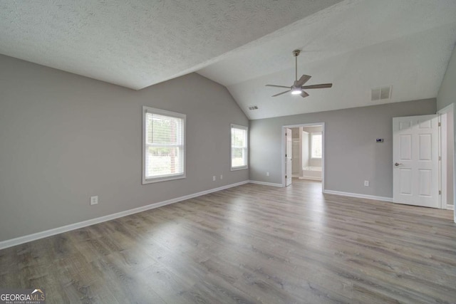 830 Buffington Way, Canton, GA 30115 - unfurnished living room with vaulted ceiling, baseboards, visible vents, wood finished floors, and ceiling fan