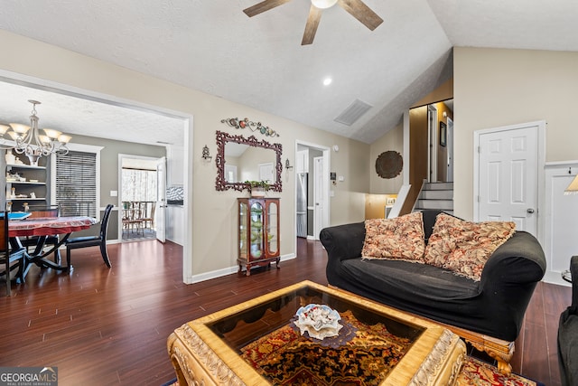 living room featuring a textured ceiling, visible vents, dark wood-type flooring, lofted ceiling, and ceiling fan with notable chandelier