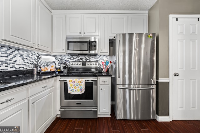 kitchen featuring white cabinetry, appliances with stainless steel finishes, and dark wood finished floors