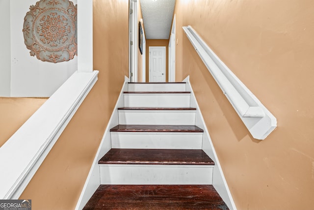 stairs with baseboards and wood finished floors
