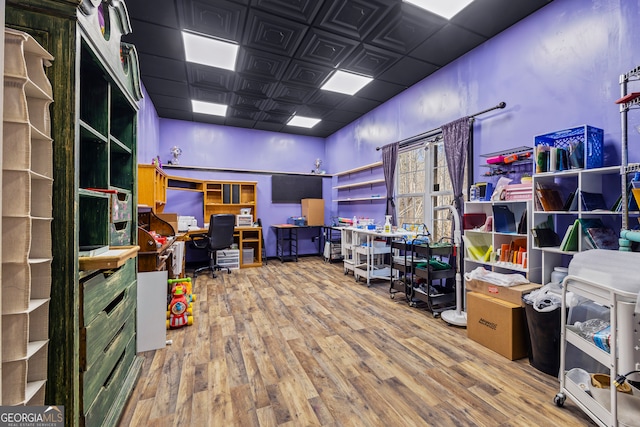 office featuring wood finished floors and a paneled ceiling
