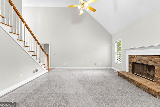 unfurnished living room with high vaulted ceiling, carpet flooring, stairway, a ceiling fan, and visible vents