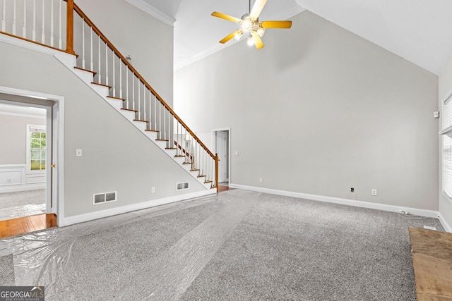 unfurnished living room featuring stairs, high vaulted ceiling, visible vents, and ceiling fan