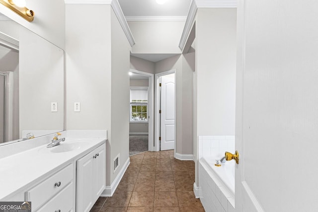 full bathroom featuring a bath, visible vents, crown molding, vanity, and tile patterned flooring