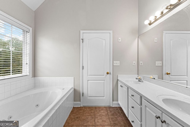 full bathroom featuring tile patterned floors, a jetted tub, a sink, lofted ceiling, and double vanity