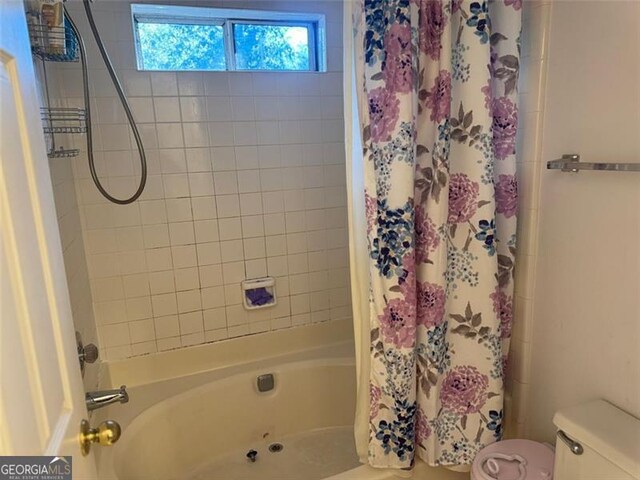 bathroom with toilet and shower / tub combo