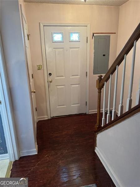 entryway featuring electric panel, stairway, wood-type flooring, a textured ceiling, and baseboards