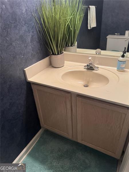 half bathroom featuring toilet and vanity