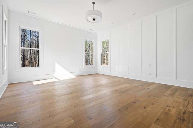 18390 Birmingham Hwy, Alpharetta, GA 30004 - spare room with visible vents, crown molding, light wood-style flooring, and a decorative wall