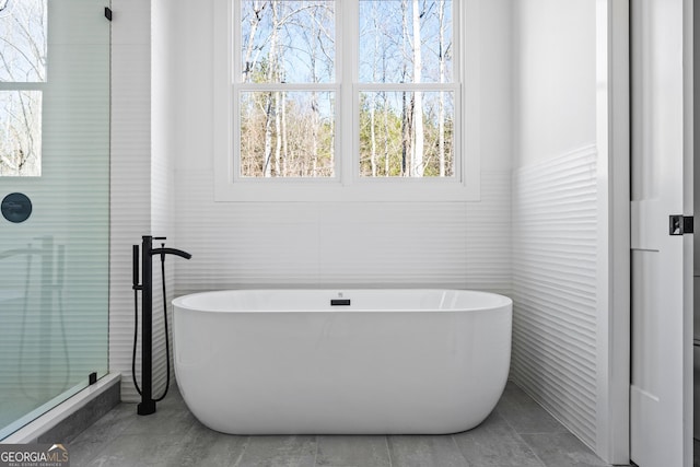 18390 Birmingham Hwy, Alpharetta, GA 30004 - bathroom featuring tile walls, a shower with shower door, a freestanding tub, and tile patterned floors