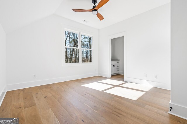 18390 Birmingham Hwy, Alpharetta, GA 30004 - unfurnished bedroom with lofted ceiling, baseboards, ensuite bath, visible vents, and light wood-style flooring