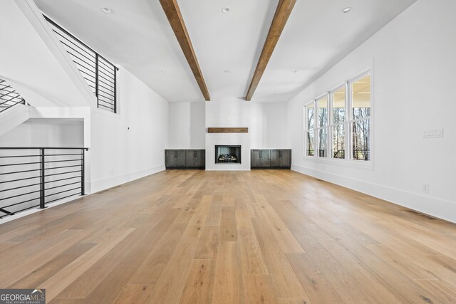 18390 Birmingham Hwy, Alpharetta, GA 30004 - unfurnished living room with baseboards, a fireplace, beam ceiling, and wood-type flooring