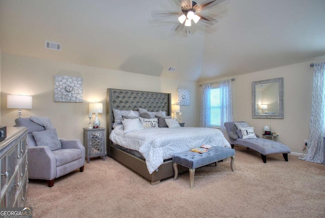 bedroom featuring ceiling fan, visible vents, light carpet, and lofted ceiling