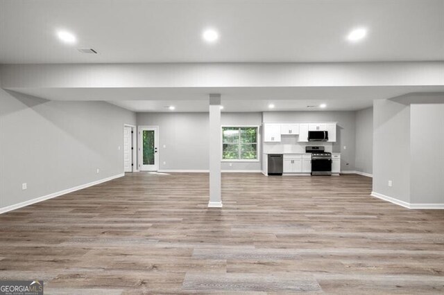 1590 Highland Farm Dr, Suwanee, GA 30024 - unfurnished living room featuring light wood finished floors, baseboards, and recessed lighting