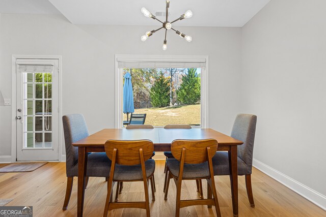 2105 Rotunda Ct, Conyers, GA 30094 - dining space with baseboards, an inviting chandelier, and light wood-type flooring