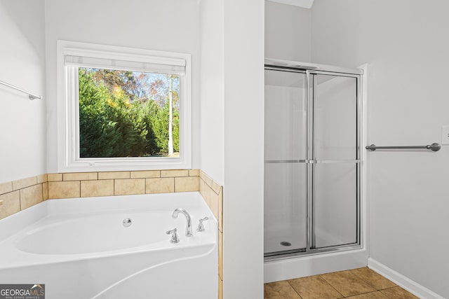 2105 Rotunda Ct, Conyers, GA 30094 - bathroom featuring tile patterned floors, a garden tub, and a shower stall