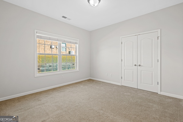2105 Rotunda Ct, Conyers, GA 30094 - unfurnished bedroom featuring baseboards, visible vents, a closet, and carpet