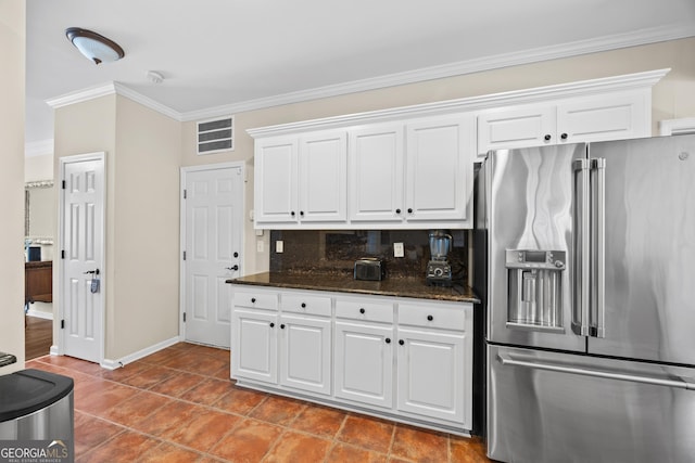kitchen with backsplash, white cabinetry, dark stone countertops, ornamental molding, and high end fridge
