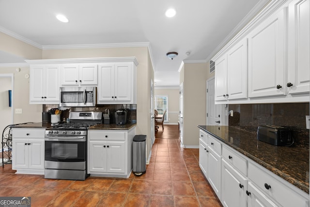 1803 Gold Finch Way, Lawrenceville, GA 30043 - kitchen featuring appliances with stainless steel finishes, tasteful backsplash, ornamental molding, white cabinets, and baseboards