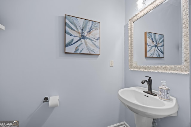bathroom featuring a sink and baseboards