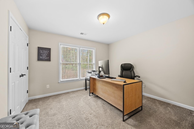 office space with baseboards, visible vents, and carpet