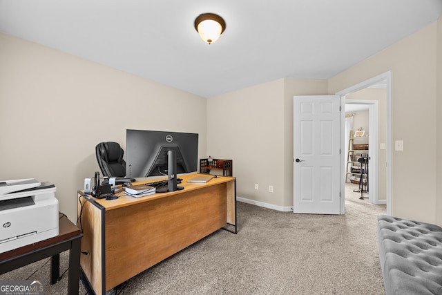 carpeted office space with baseboards