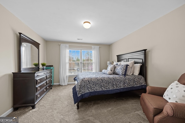 bedroom featuring baseboards, light colored carpet, and visible vents