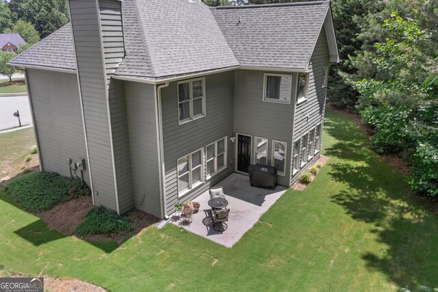 1803 Gold Finch Way, Lawrenceville, GA 30043 - rear view of property with roof with shingles, a patio area, a lawn, and a chimney