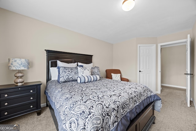 carpeted bedroom featuring baseboards