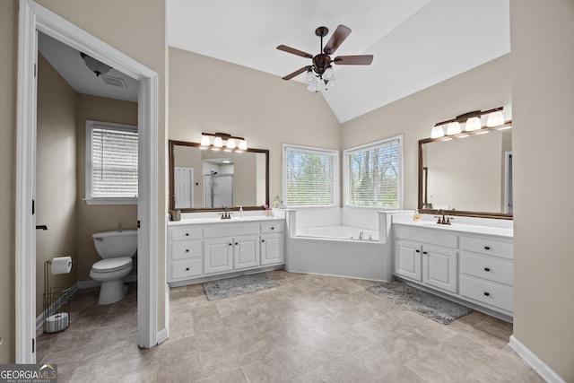 1803 Gold Finch Way, Lawrenceville, GA 30043 - bathroom featuring a garden tub, plenty of natural light, a ceiling fan, two vanities, and lofted ceiling