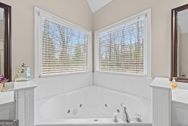 1803 Gold Finch Way, Lawrenceville, GA 30043 - bathroom featuring a tub with jets, vanity, and vaulted ceiling
