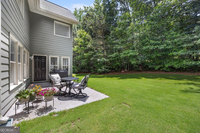 1803 Gold Finch Way, Lawrenceville, GA 30043 - view of green lawn featuring a patio area
