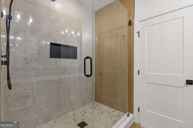 full bathroom with a marble finish shower