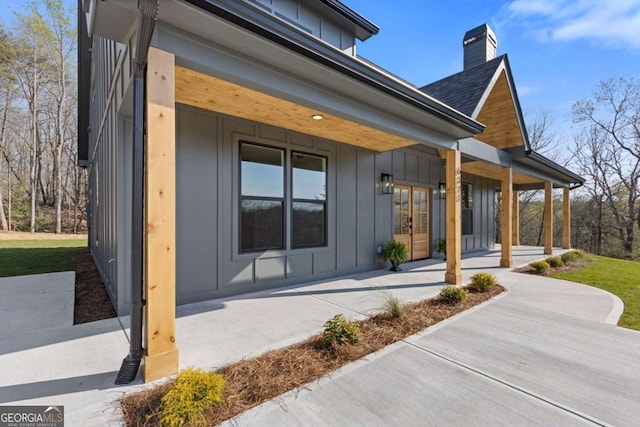 exterior space with board and batten siding and a porch