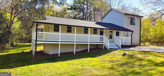 view of front of property with covered porch, a shingled roof, and a front lawn