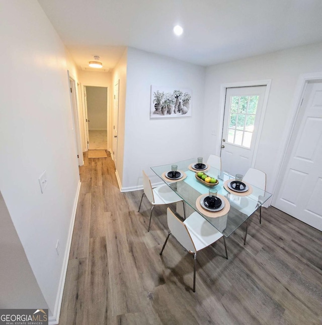dining area featuring baseboards and wood finished floors