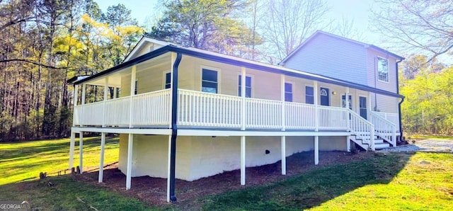 view of property exterior featuring covered porch and a yard