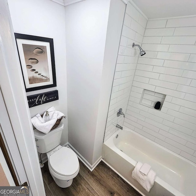 full bathroom featuring toilet, shower / bathing tub combination, baseboards, and wood finished floors