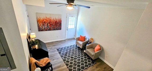 sitting room with baseboards, wood finished floors, and ceiling fan