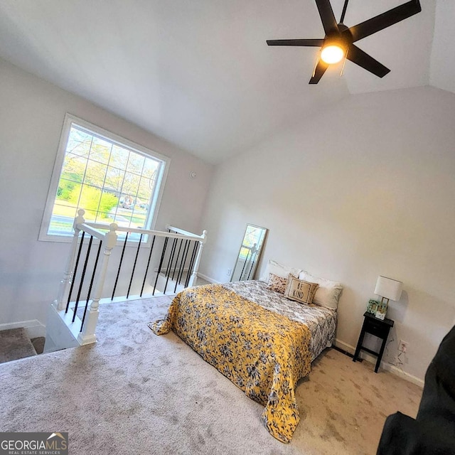 bedroom featuring carpet floors, baseboards, lofted ceiling, and ceiling fan
