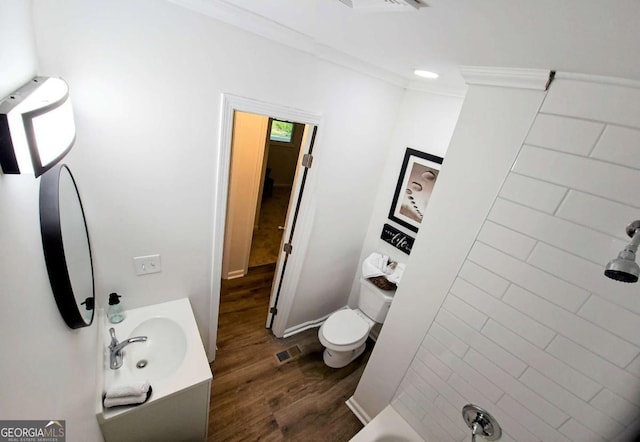full bathroom featuring vanity, crown molding, toilet, visible vents, and wood finished floors